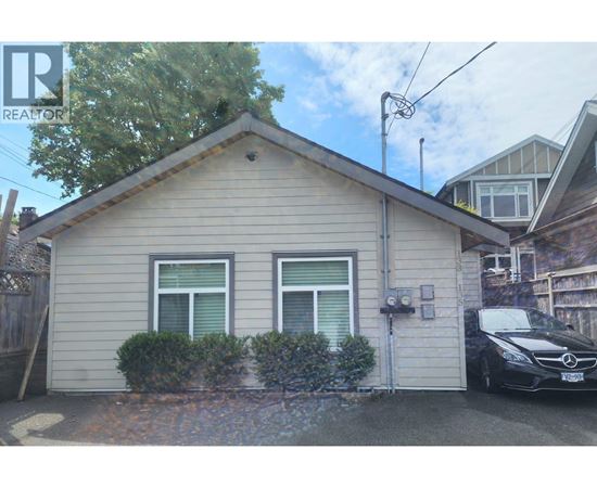 A small house with a car parked in front.