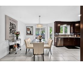 A modern dining room with a glass table and chairs.