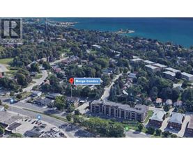 An aerial view of a coastal town with a Merge Condo signposted.
