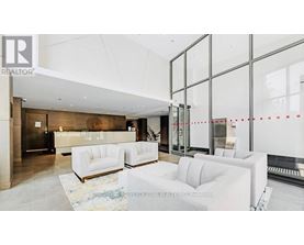 A realtor's office with white furniture and glass walls.