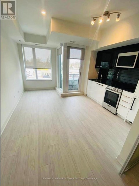 A kitchen with black countertops and white cabinets.