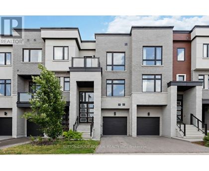 A row of modern townhouses with garages and balconies.