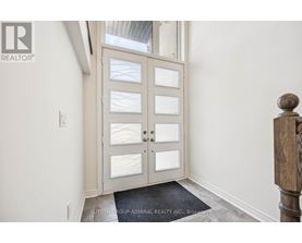A door with glass panels and a mat on the floor.