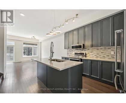A modern kitchen with dark wood cabinets and a white island.
