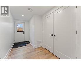 A white door with a black mat in front of it.