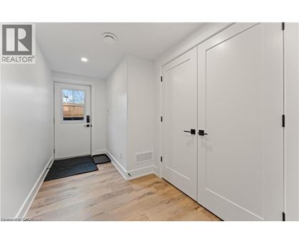 A white door with a black mat in front of it.