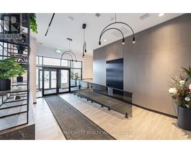 A modern office lobby with a glass wall and a reception desk.