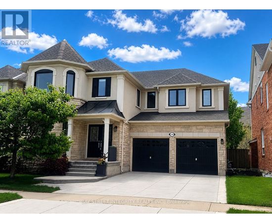A large, two-story house with a garage is for sale.