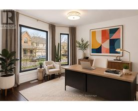 A well-lit room with a desk, chair, and a large window showing an outdoor view.