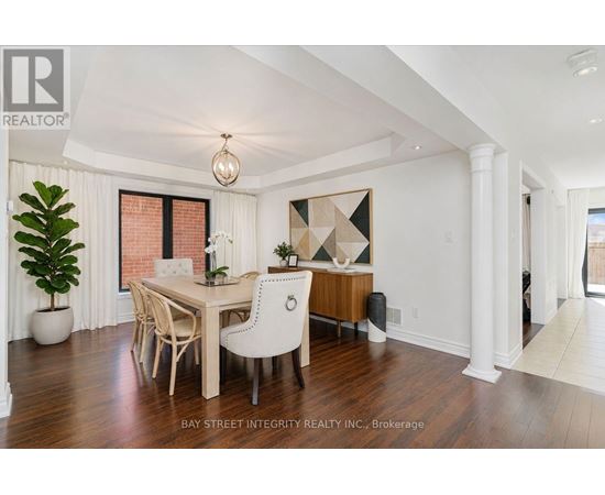 A dining room with a wooden table and chairs.