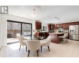 A modern kitchen with a dining table and chairs.