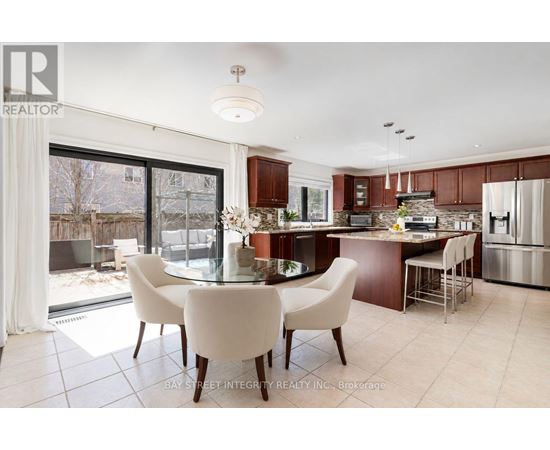 A modern kitchen with a dining table and chairs.