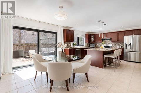 A modern kitchen with a dining table and chairs.