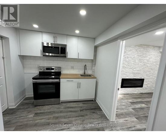 A kitchen with a stove top oven and microwave above a counter.