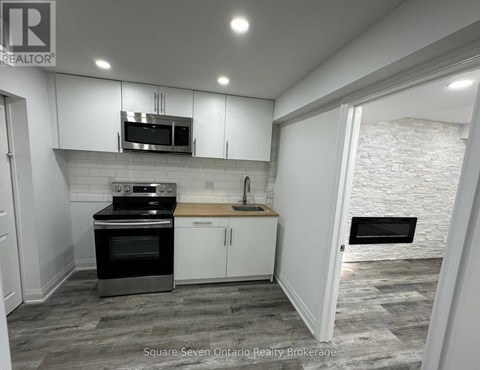 A kitchen with a stove top oven and microwave above a counter.