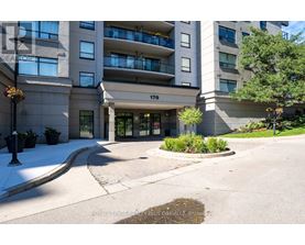 The front of apartment building number 170 with a landscaped area in front.