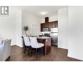 A kitchen with white chairs and a white table.