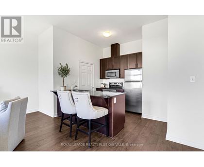 A kitchen with white chairs and a white table.