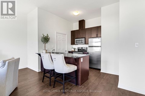 A kitchen with white chairs and a white table.