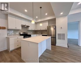 A modern kitchen with white cabinets and a center island.