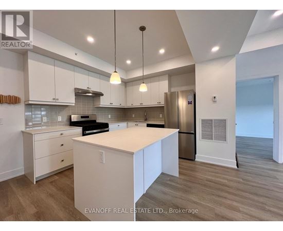 A modern kitchen with white cabinets and a center island.