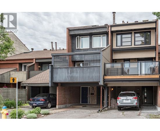 A modern two-story house with a balcony and a garage.