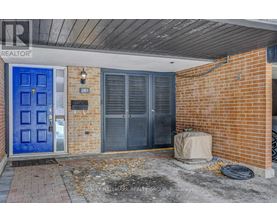 A blue door is on the left side of a brick building.