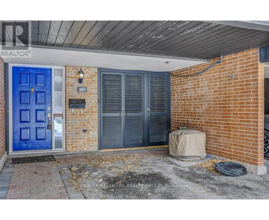 A blue door is on the left side of a brick building.