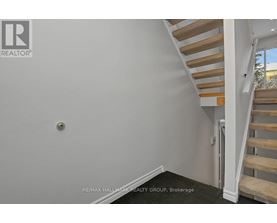 A staircase with wooden steps and white railings.