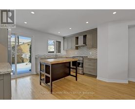 A kitchen with a table and chairs in the middle of the room.