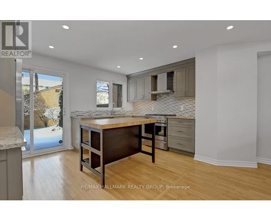 A kitchen with a table and chairs in the middle of the room.