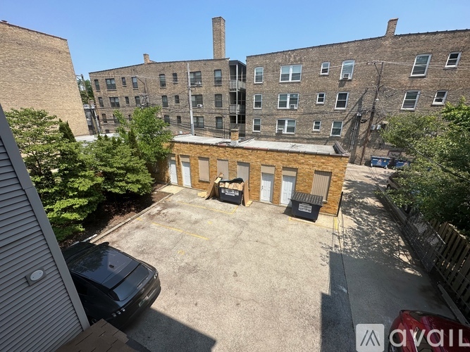 A parking lot with a car and a building in the background.