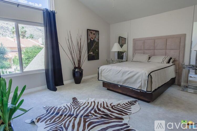 A bedroom with a zebra rug on the floor.