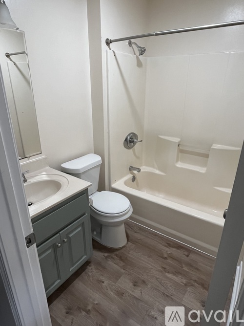 A bathroom with a toilet, sink, and bathtub.