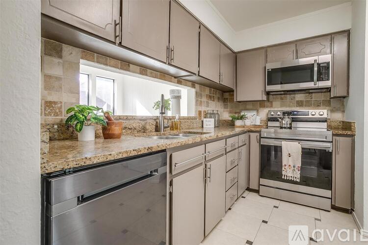 A kitchen with a stainless steel dishwasher and oven.