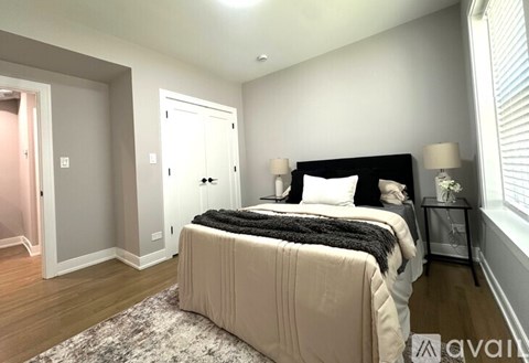 A bedroom with a large bed and a window.