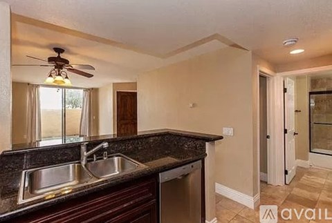 A kitchen with a sink and a fan.