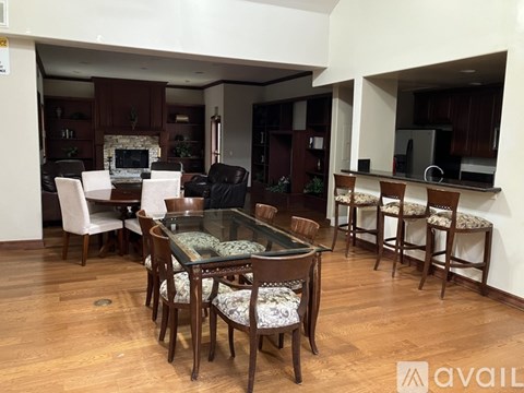 A dining room with a glass table and chairs.