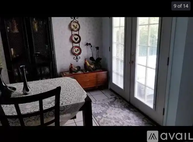 A dining room with a table and chairs.