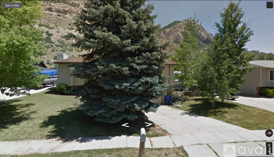 A Google Maps image of a residential area with houses and trees.