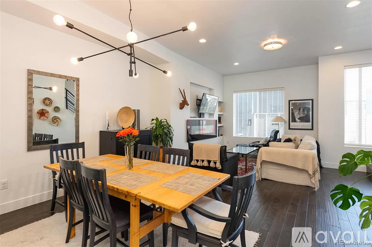 A dining room with a wooden table and chairs.