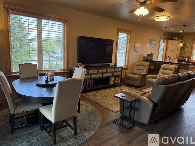 A well-lit dining room with a table set for four.