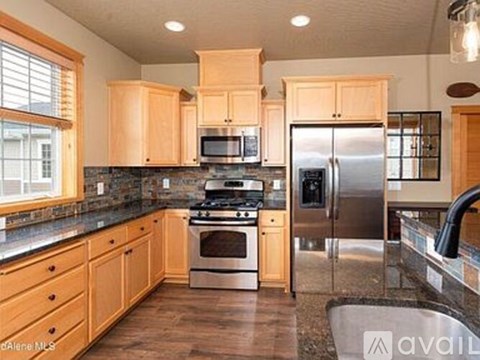 A kitchen with wooden cabinets and stainless steel appliances.