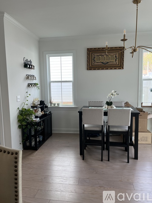 A dining room with a table and chairs.