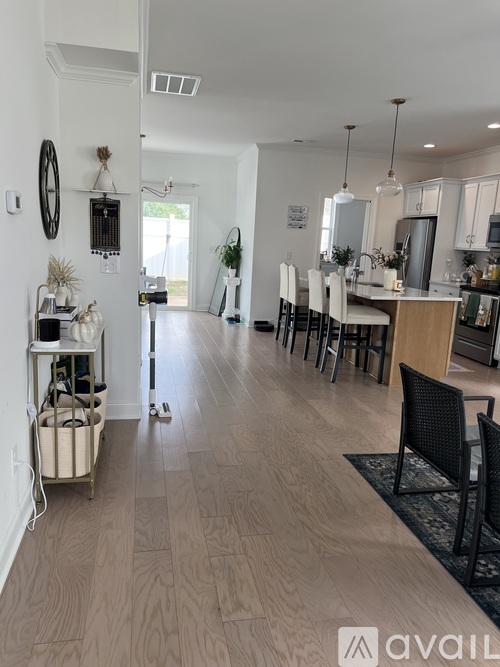A kitchen with a dining table and chairs.