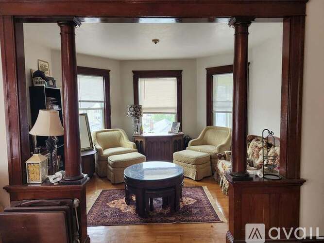 A living room with a large mirror and a coffee table.