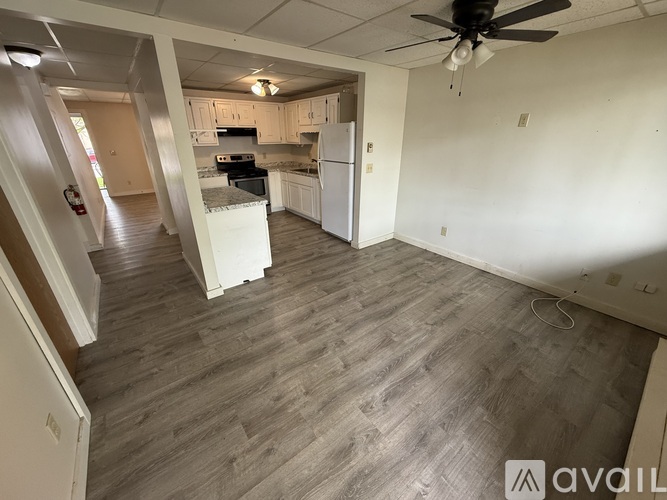 A kitchen with white appliances and wooden cabinets.