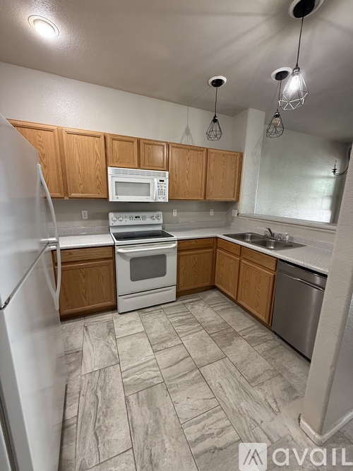 A kitchen with wooden cabinets and a white refrigerator.