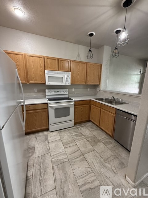 A kitchen with wooden cabinets and a white refrigerator.
