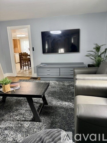 A living room with a black coffee table and a grey sofa.